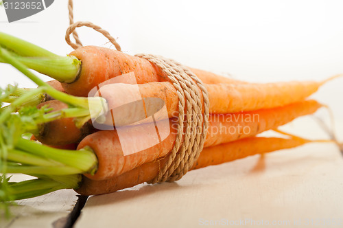Image of baby carrots bunch tied with rope