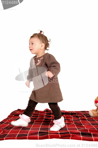 Image of Baby girl walking away,