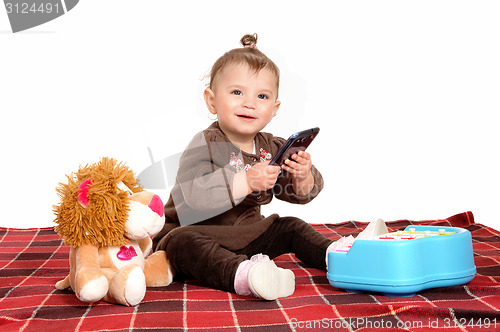 Image of Baby playing with cell phone.
