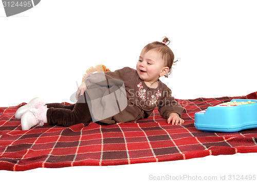 Image of Smiling girl lying on floor.