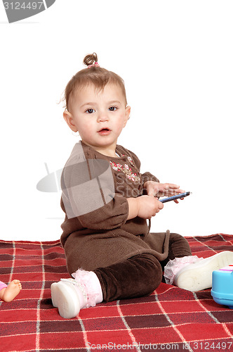 Image of Baby girl sitting on blanket.