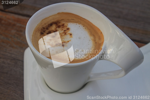 Image of  cappuccino coffee on wooden table