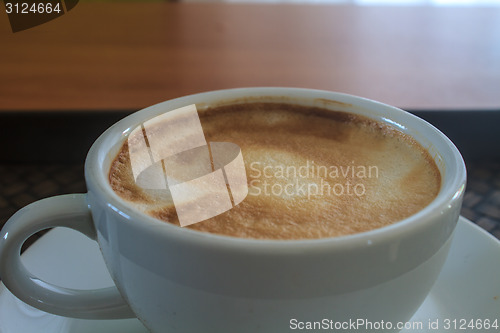 Image of cappuccino coffee on wooden table