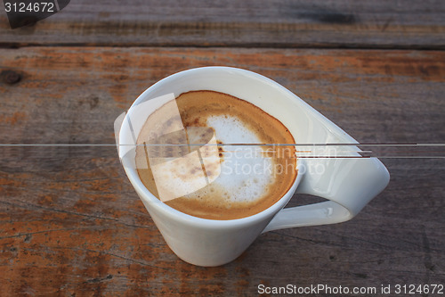 Image of  cappuccino coffee on wooden table