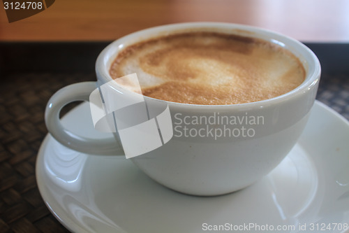 Image of cappuccino coffee on wooden table