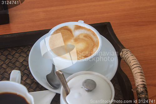 Image of cappuccino coffee on wooden table