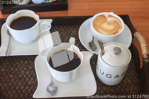 Image of cappuccino and black  coffee on wooden table