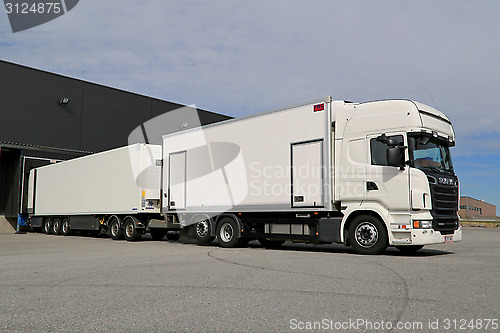 Image of White Scania R560 Full Trailer Unloading at a Warehouse