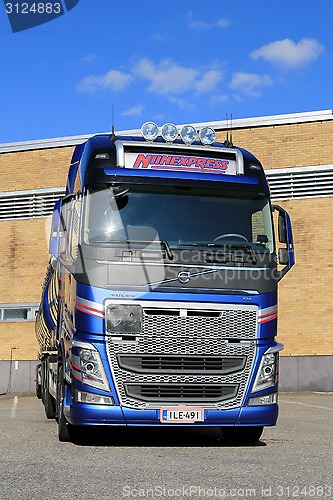 Image of New Volvo FH Tank Truck by a Warehouse, Vertical View