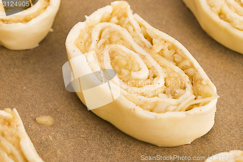 Image of Puff pastry cookies with apple and cinnamon before baking