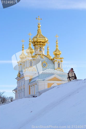 Image of young women near beautiful church in winer. Petergof, St. Petersburg, Russia