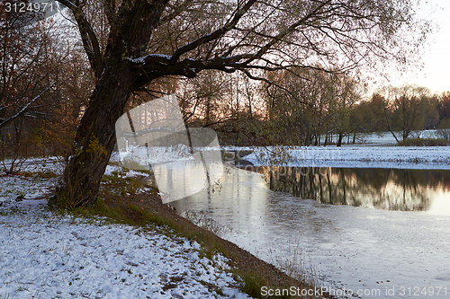 Image of landscape late autumn evening freezing river park