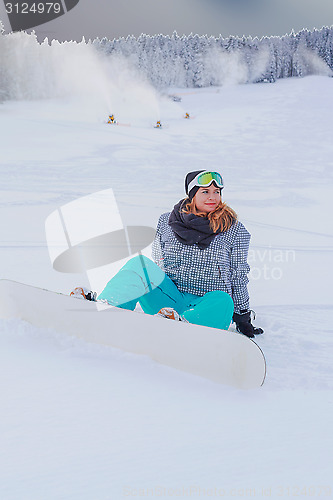 Image of Young girl Oversized sitting with your snowboard in the snow