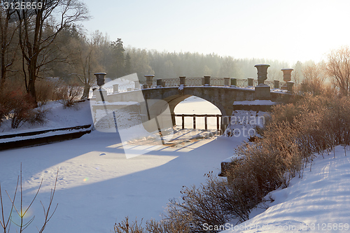 Image of winter  landscape with old bridge sunny day