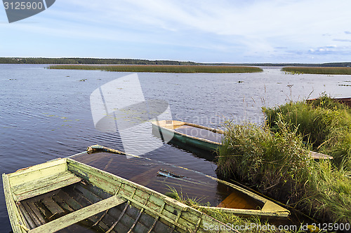 Image of Old boats in nothern wild lake 