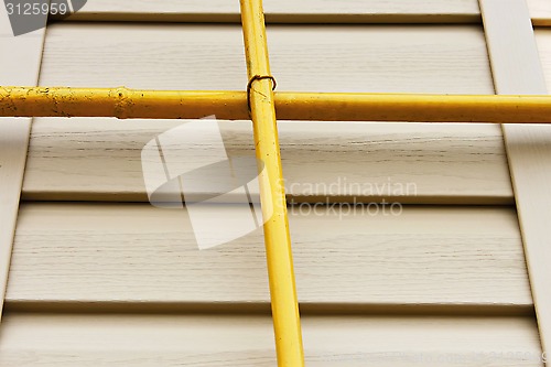 Image of Two gas pipes over the siding wall