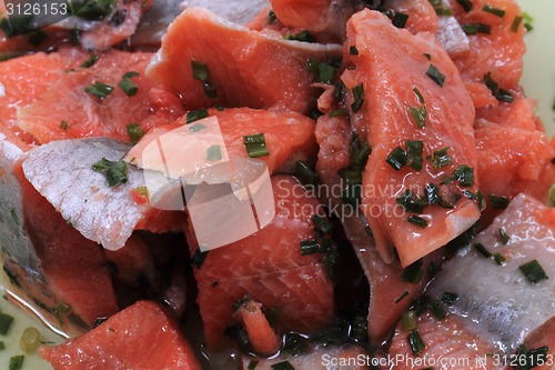 Image of salmon fish with green herbs