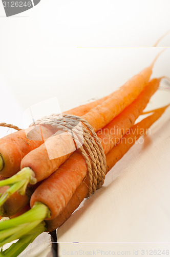 Image of baby carrots bunch tied with rope