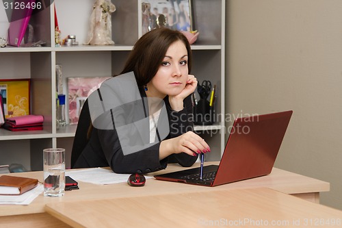 Image of Sad girl at computer prints the document