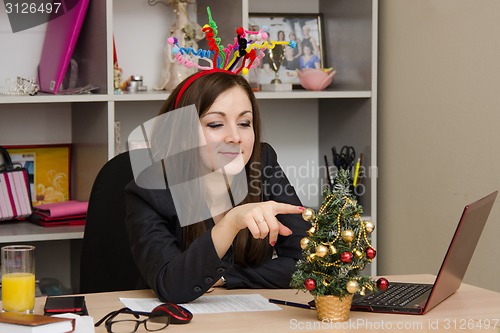 Image of Girl in the office, decorated for new year