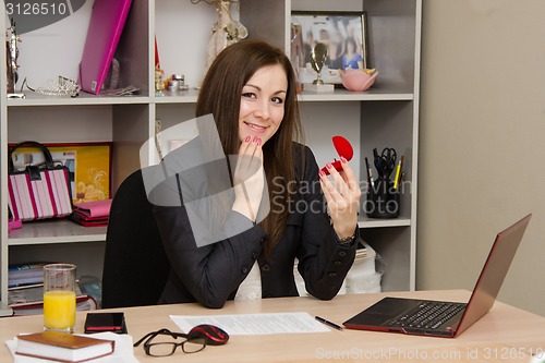 Image of Joyful girl in the office holding a box with ring