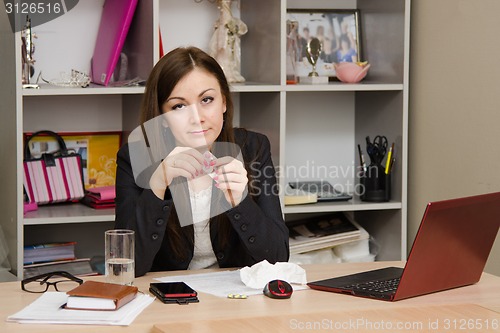 Image of Girl in the office is going to take a pill