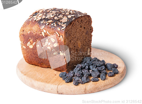 Image of Unleavened bread with seeds on wooden board with raisins