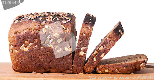 Image of Unleavened bread with seeds sliced on cutting board