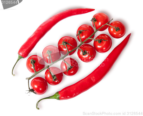 Image of Two chili pepper and cherry tomatoes on stem top view