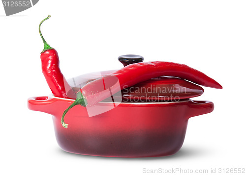 Image of Two red chili peppers in saucepan with lid