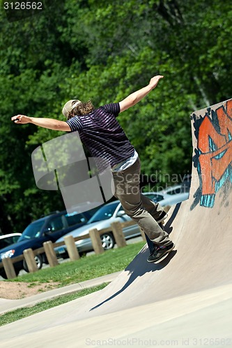 Image of Skateboarder Riding Skate Ramp