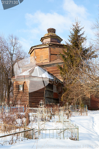 Image of destroyed old Wooden  church on orthodox cemetery in winter, Russia