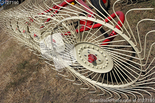 Image of New hay raker farm equipment. Agricultural machinery