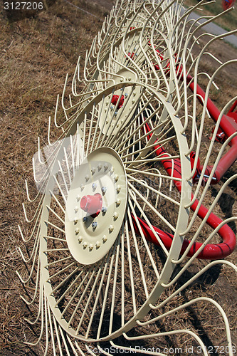 Image of New hay raker farm equipment. Agricultural machinery