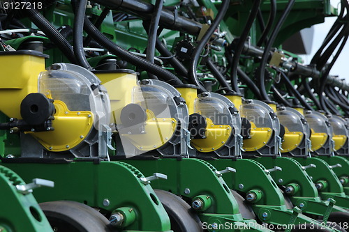 Image of tractor and seeder planting crops on a field