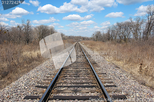 Image of Railway to horizon and clouds on the sky background.