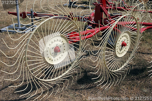 Image of New hay raker farm equipment. Agricultural machinery