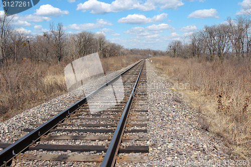 Image of Railway to horizon and clouds on the sky background.