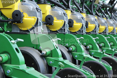 Image of tractor and seeder planting crops on a field