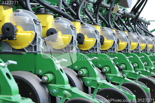 Image of tractor and seeder planting crops on a field