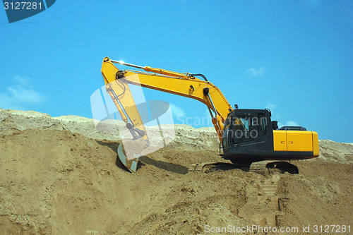 Image of Yellow excavator, excavation work at a construction site.