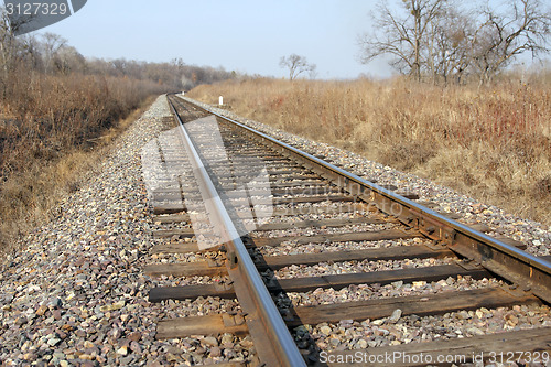 Image of Railway to horizon and clouds on the sky background.