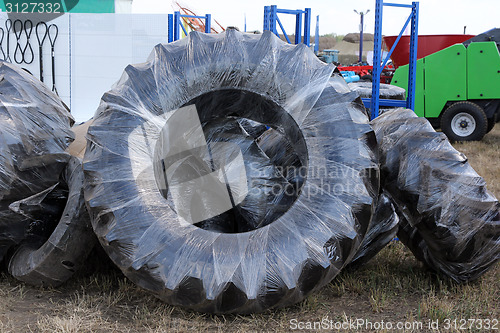 Image of wheels of tractors tire and farm equipment in the package.