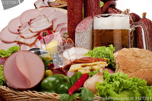 Image of A composition of meat and vegetables with beer