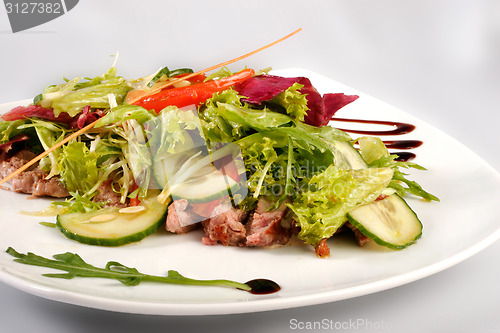 Image of A plate of pork with vegetables. File includes clipping path for