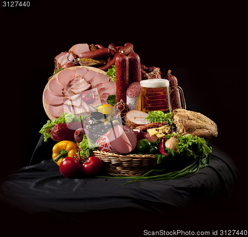 Image of A composition of meat and vegetables with beer