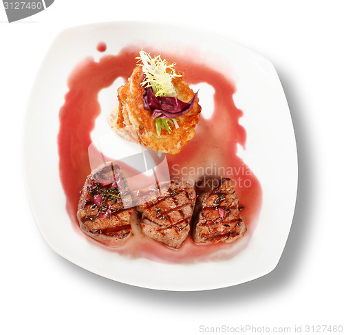 Image of Veal Medallions with potato pancakes. Closeup. File includes cli