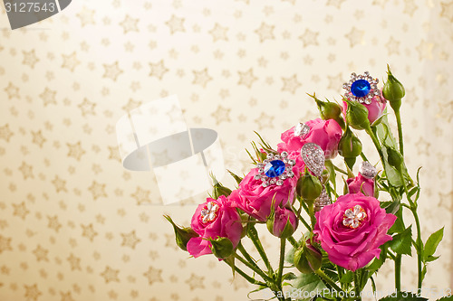 Image of Pink roses with jewellery