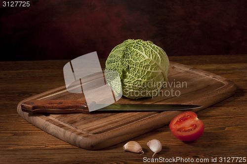 Image of Green cabbage on wooden tablet