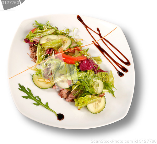 Image of A plate of pork with vegetables. File includes clipping path for